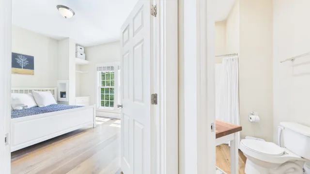 a kitchen with stainless steel appliances granite countertop a stove top oven a sink dishwasher and a refrigerator with wooden floor