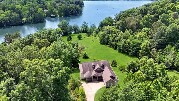 a living room with a bed furniture and a flat screen tv