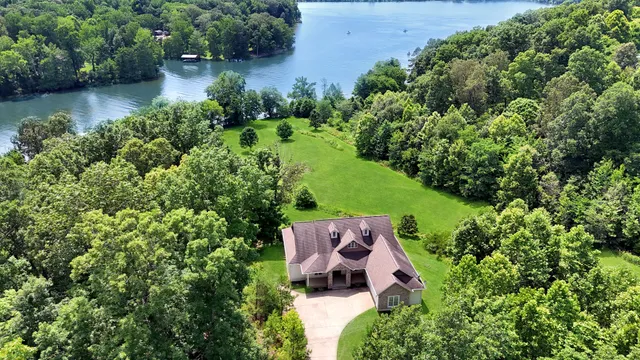 a living room with a bed furniture and a flat screen tv