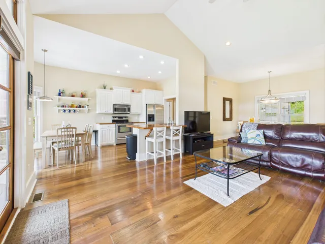 a view of a livingroom with furniture wooden floor and a rug