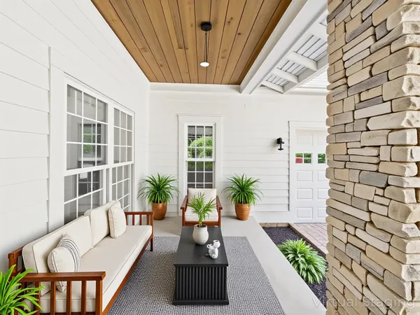 a bedroom with a large bed couch and a window