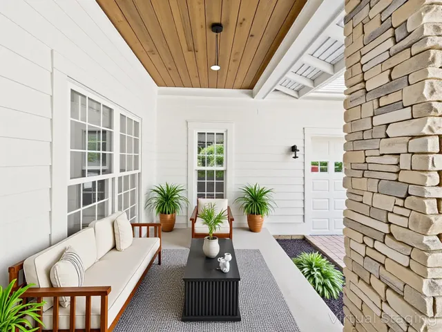 a bedroom with a large bed couch and a window