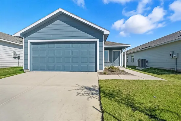 a front view of house with yard and garage