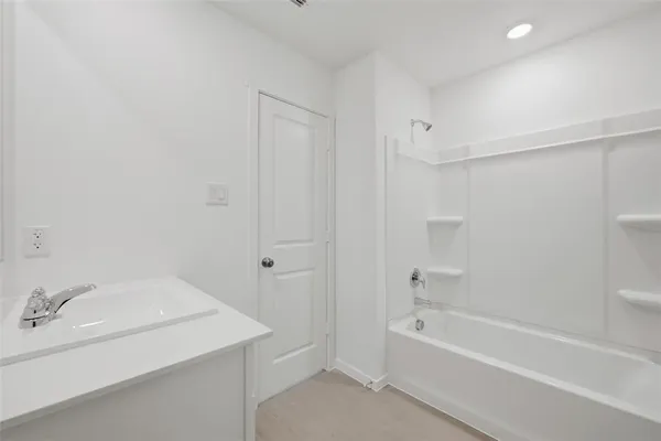 a bathroom with a toilet a sink a mirror and vanity