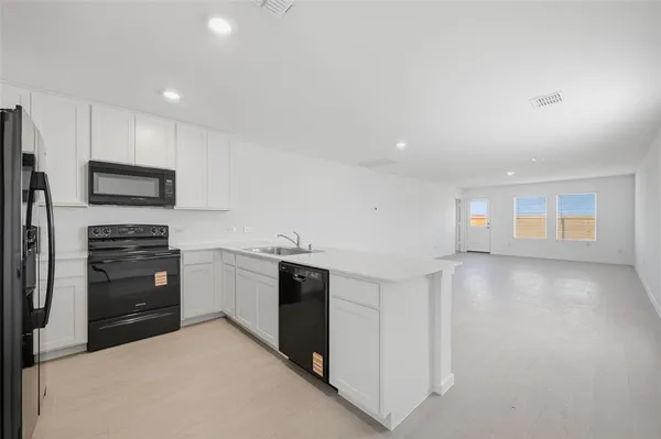 a kitchen with stainless steel appliances a refrigerator sink and microwave