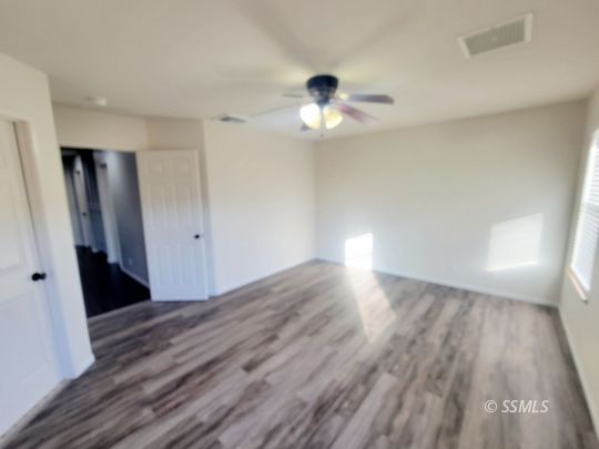 1113 West Iowa Avenue Ridgecrest, CA 93555 - Photo 16 of 21 wooden floor in an empty room with a window