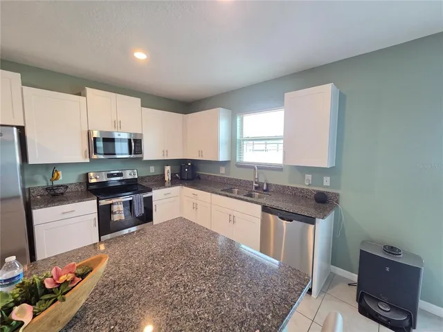 a living room with lots of furniture and a window