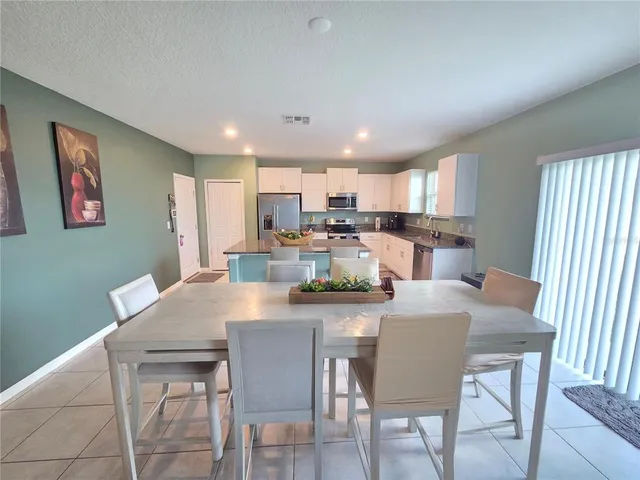 a living room with furniture a rug and a large window
