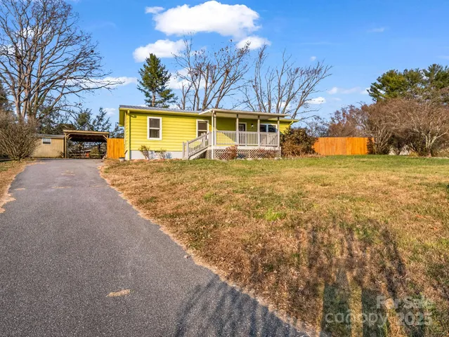 a view of a yard with yellow house