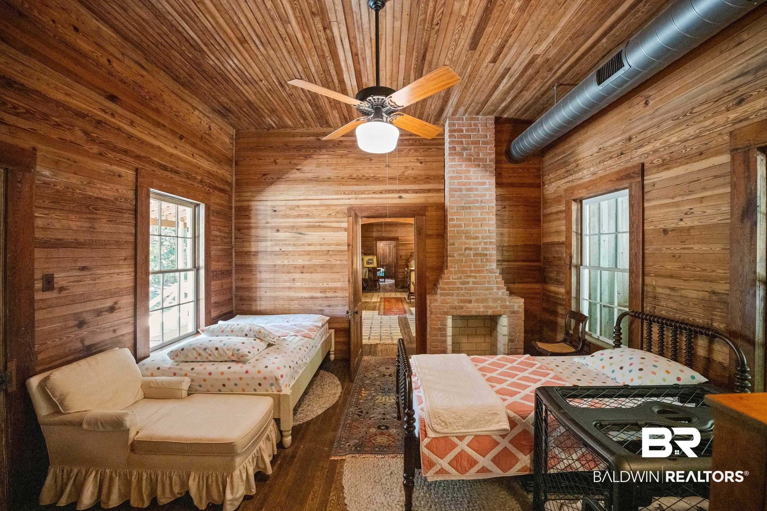 30671 Magnolia Street Elberta, AL 36530 - Photo 26 of 68 Bedroom featuring wood walls, wooden ceiling, and wood finished floors