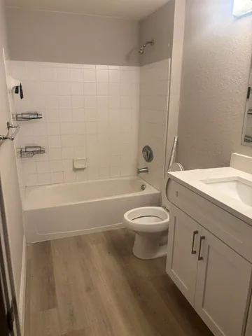 a bathroom with a toilet a sink and bathtub