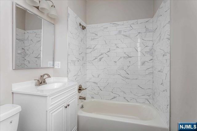 20 Dankoff Avenue, Unit 1 Wallington, NJ 07057 - Photo 8 of 15 a bathroom with a sink and a mirror