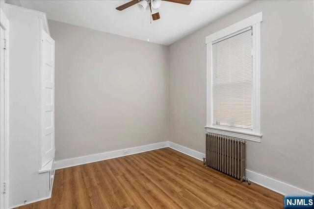 20 Dankoff Avenue, Unit 1 Wallington, NJ 07057 - Photo 9 of 15 a view of an empty room with wooden floor and a window