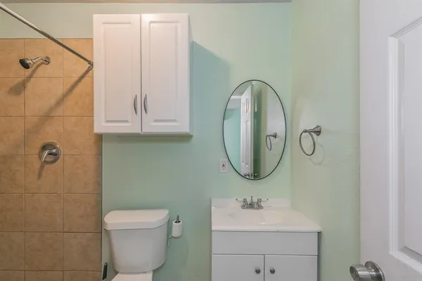 a bathroom with a sink a toilet and a mirror