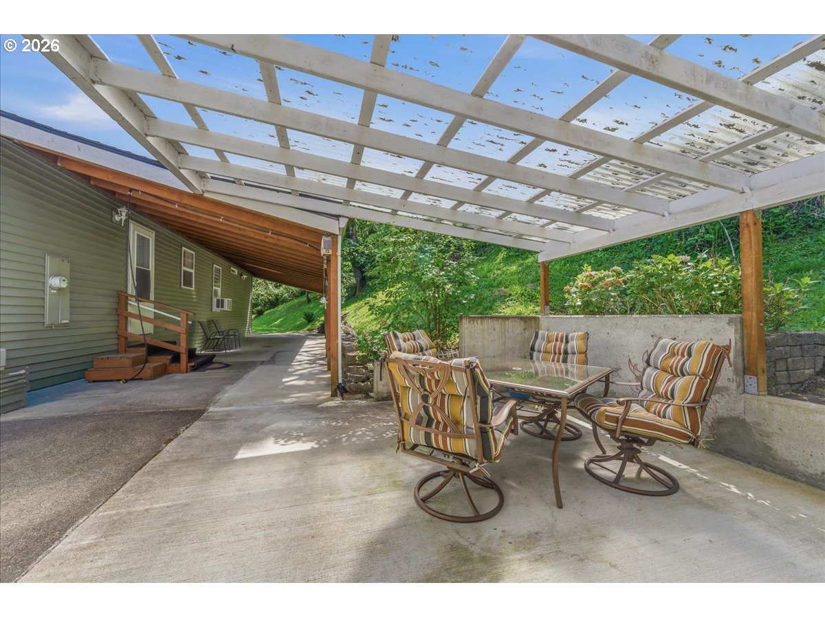475 East 9th Street Rainier, OR 97048 - Photo 28 of 43 a view of a patio with table and chairs next to a yard