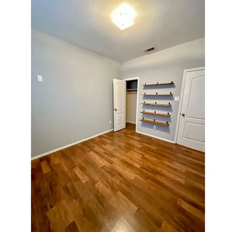 a bedroom with a bed and cabinets