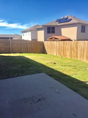 a view of a house with a backyard and a tub