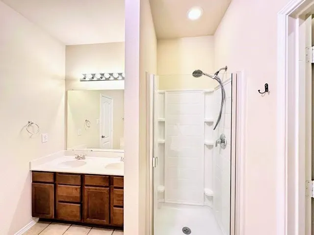 a bathroom with a sink a mirror and a shower
