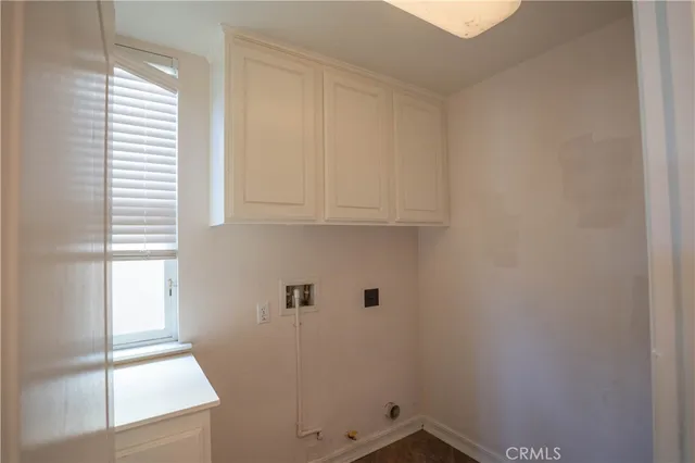 a view of a livingroom with wooden floor and a window