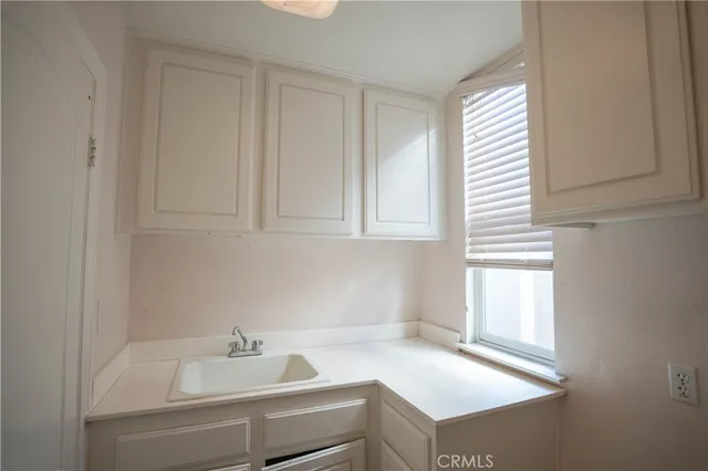 a bathroom with a tub a sink and a window