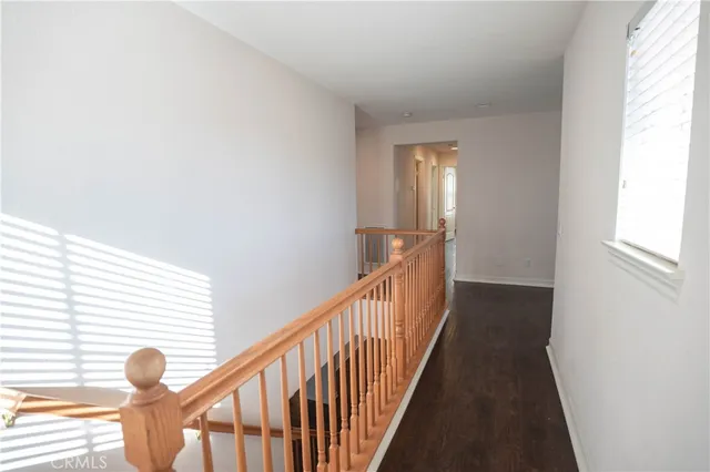 a view of balcony with wooden floor and fence