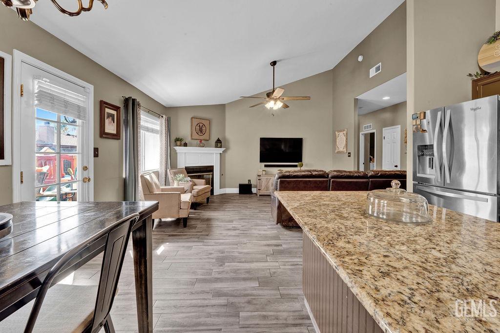 Undisclosed Address Bakersfield, CA 93307 - Photo 11 of 30 a large living room with stainless steel appliances granite countertop furniture and a flat screen tv