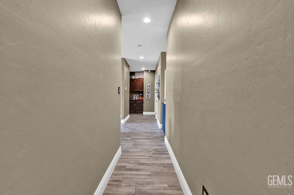 Undisclosed Address Bakersfield, CA 93307 - Photo 12 of 30 a view of a hallway with wooden floor