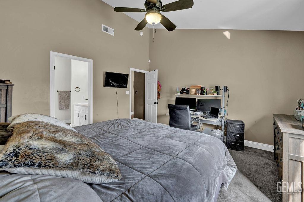 Undisclosed Address Bakersfield, CA 93307 - Photo 14 of 30 a bedroom with a bed and a chandelier