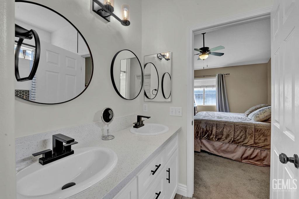 Undisclosed Address Bakersfield, CA 93307 - Photo 15 of 30 a bathroom with a two sinks and a mirror