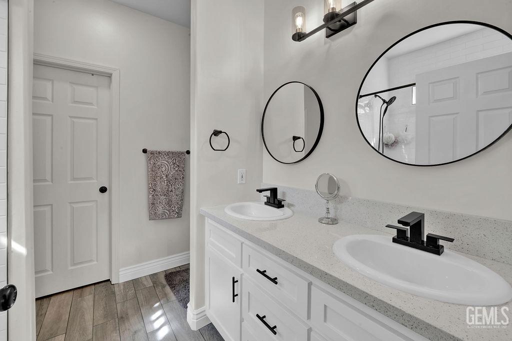 Undisclosed Address Bakersfield, CA 93307 - Photo 16 of 30 a bathroom with a sink and a mirror