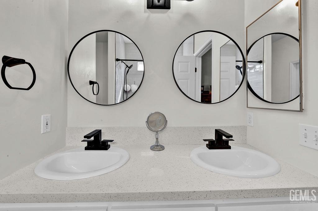 Undisclosed Address Bakersfield, CA 93307 - Photo 17 of 30 a bathroom with mirror and sink