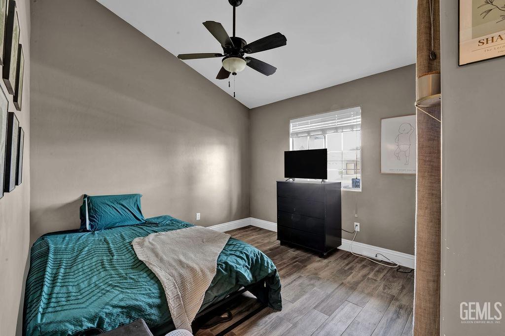 Undisclosed Address Bakersfield, CA 93307 - Photo 20 of 30 a bedroom with a bed and a ceiling fan