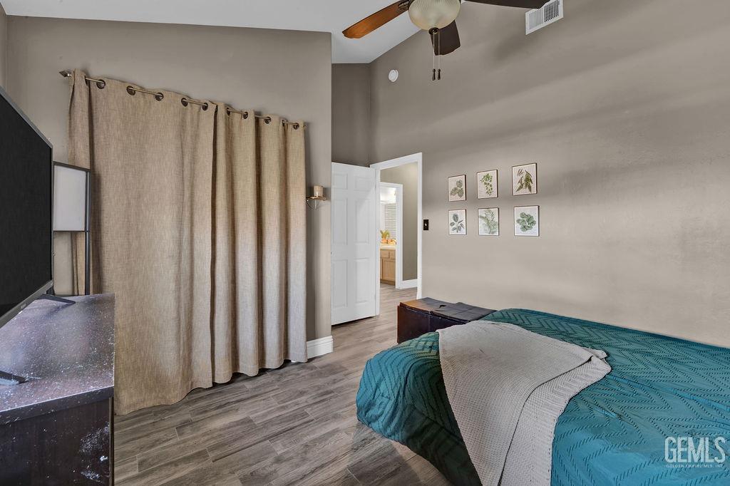 Undisclosed Address Bakersfield, CA 93307 - Photo 21 of 30 a bedroom with a bed and a mirror