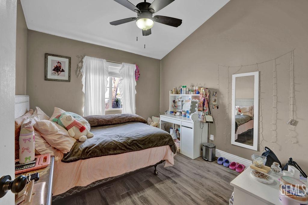 Undisclosed Address Bakersfield, CA 93307 - Photo 22 of 30 a bedroom with a bed and a chandelier