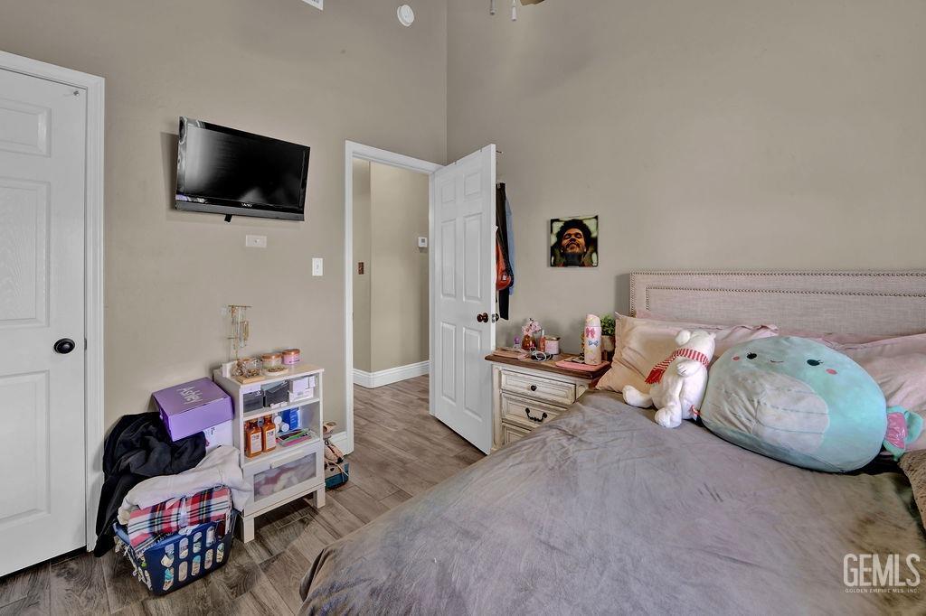 Undisclosed Address Bakersfield, CA 93307 - Photo 23 of 30 a bedroom with furniture and a flat screen tv