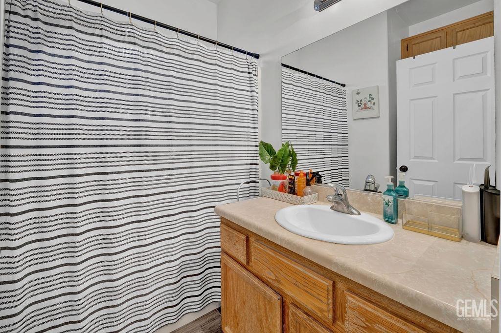 Undisclosed Address Bakersfield, CA 93307 - Photo 24 of 30 a bathroom with a sink and a mirror