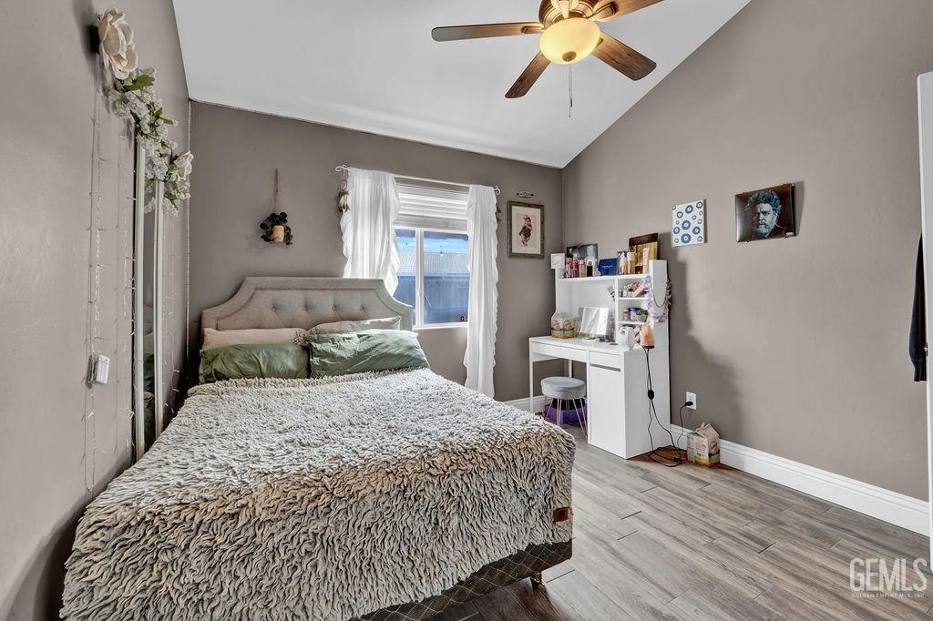 Undisclosed Address Bakersfield, CA 93307 - Photo 26 of 30 a bedroom with a bed and a chandelier