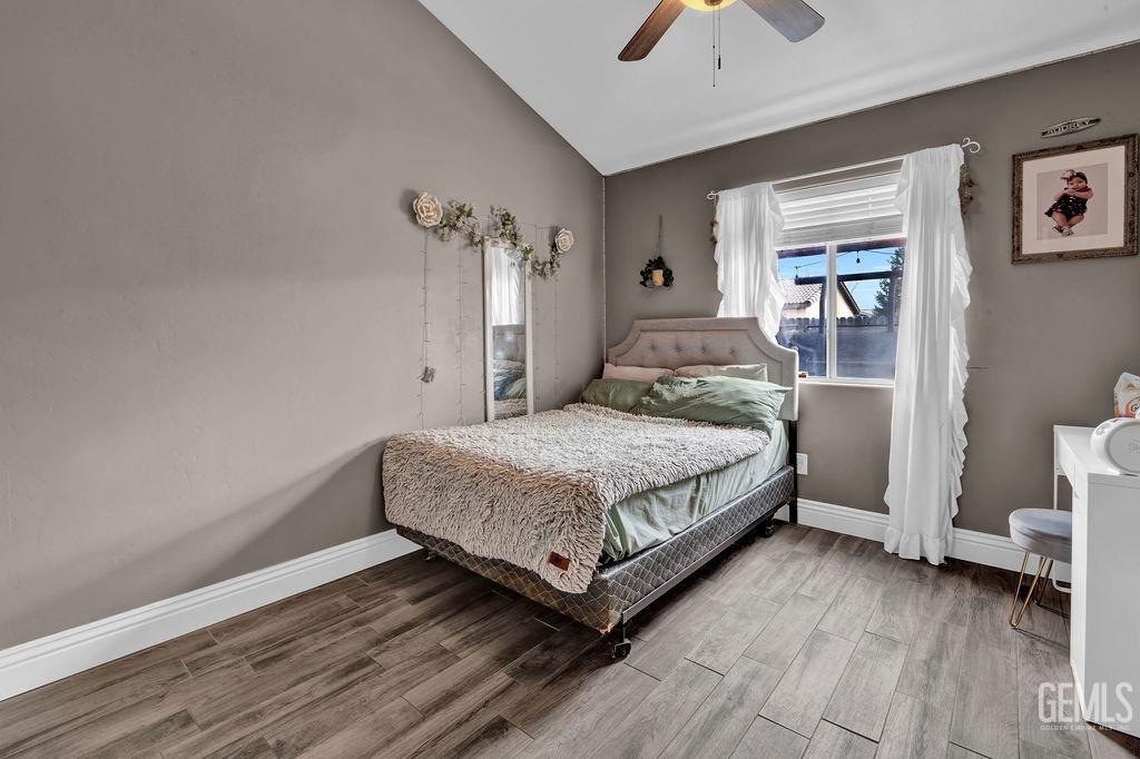 Undisclosed Address Bakersfield, CA 93307 - Photo 27 of 30 a bedroom with a bed and a chandelier