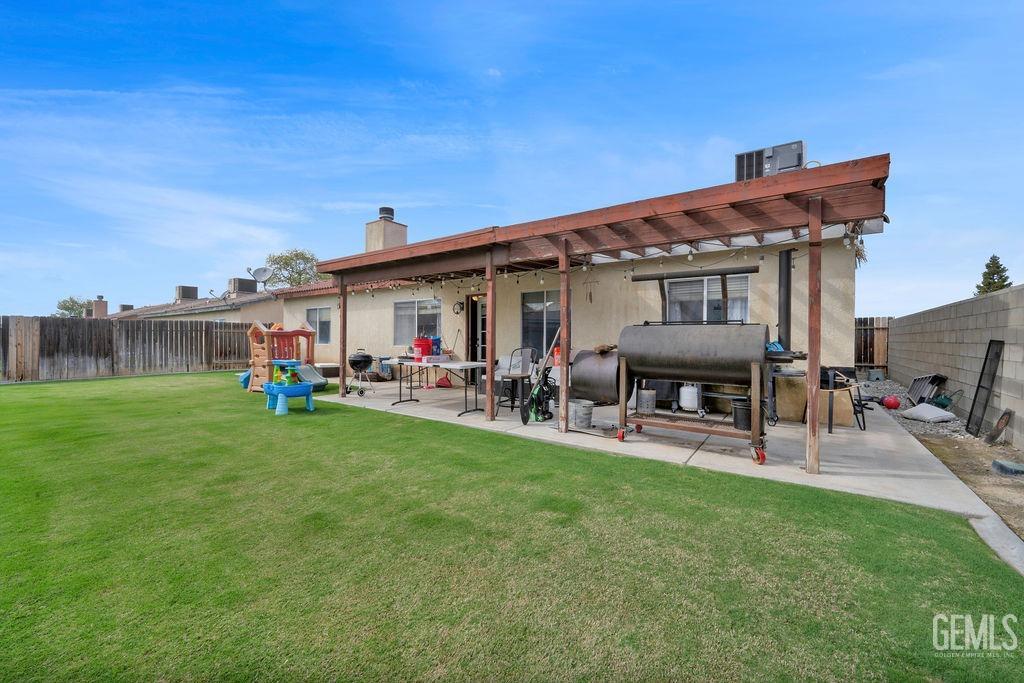 Undisclosed Address Bakersfield, CA 93307 - Photo 29 of 30 a view of a house with backyard porch and sitting area