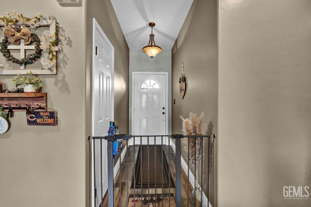 Undisclosed Address Bakersfield, CA 93307 - Photo 4 of 30 a view of a hallway with wooden floor and entryway