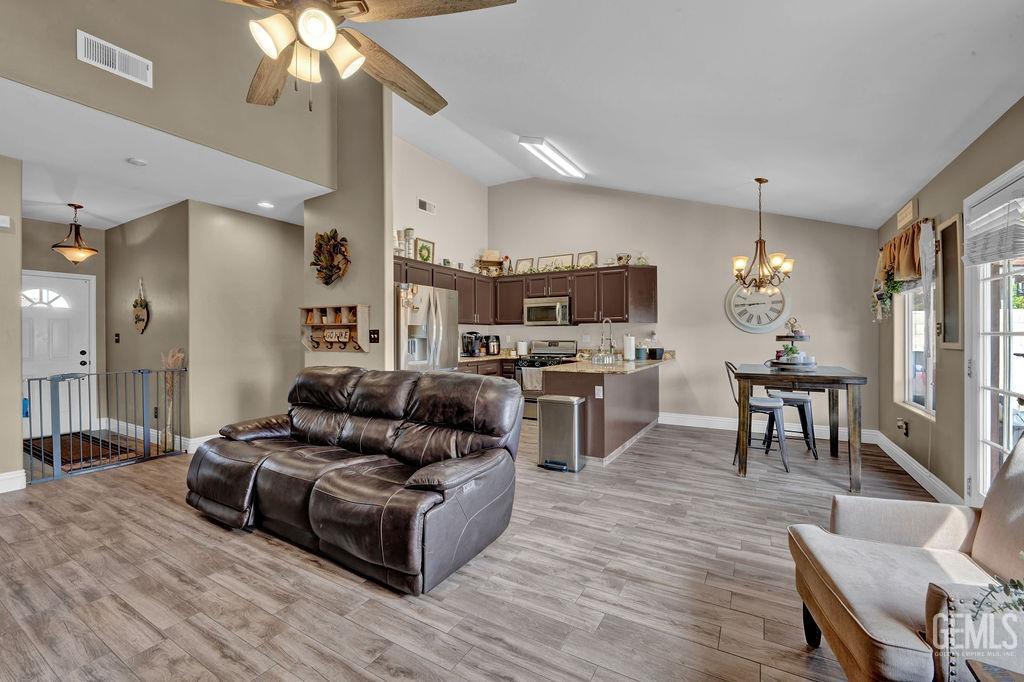 Undisclosed Address Bakersfield, CA 93307 - Photo 8 of 30 a living room with stainless steel appliances kitchen island granite countertop furniture and a kitchen view