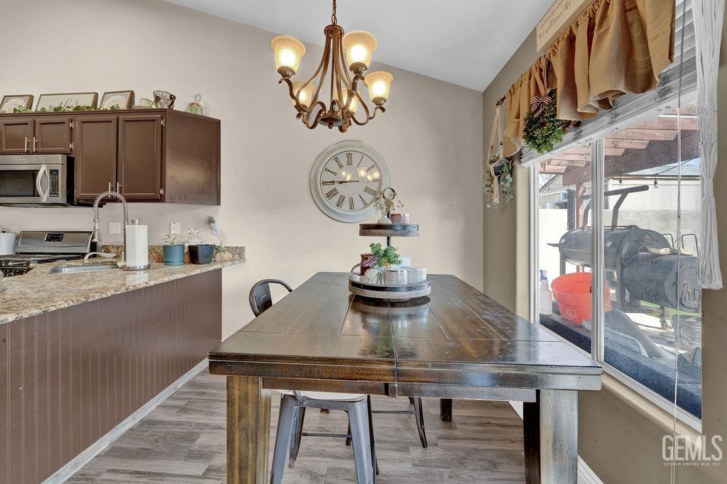 Undisclosed Address Bakersfield, CA 93307 - Photo 10 of 30 a kitchen with a table and chairs in it
