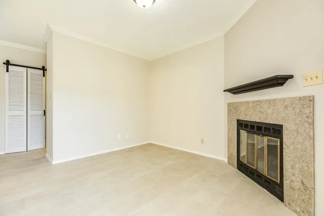 a view of an empty room with a fireplace
