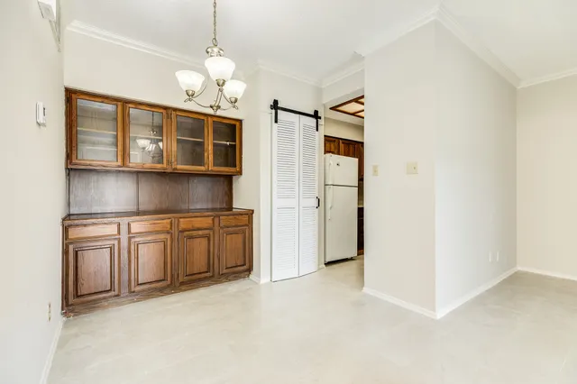 a kitchen with cabinets and window