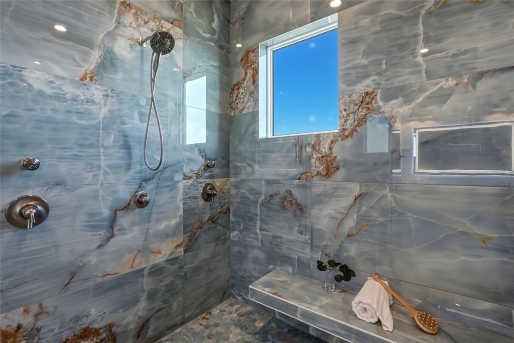 534 Crystal Drive Madeira Beach, FL 33708 - Photo 34 of 68 a bathroom with a granite countertop shower a sink and a toilet