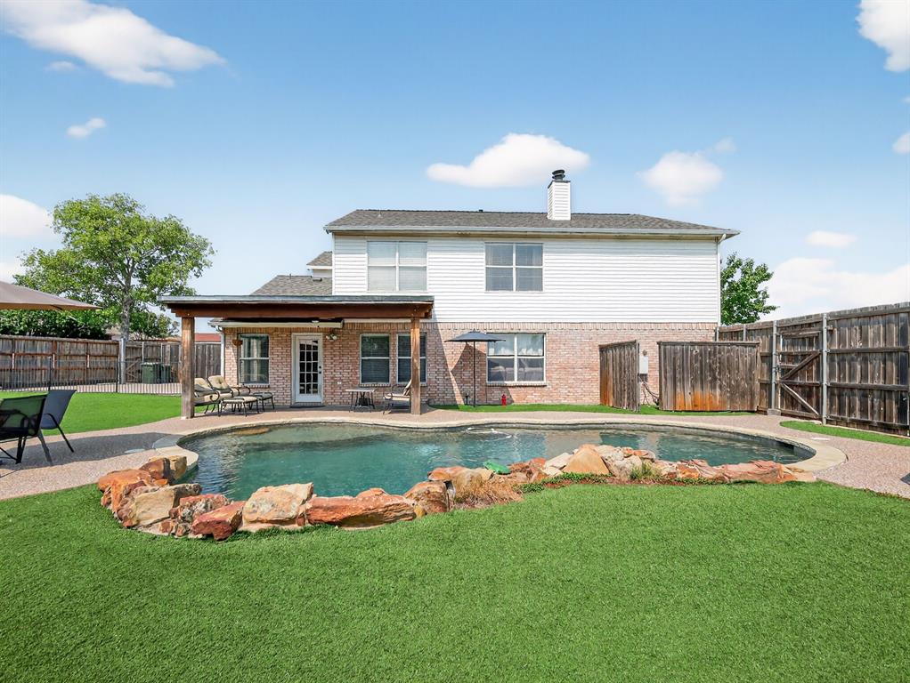 2052 Diamond Ridge Drive Carrollton, TX 75010 - Photo 11 of 40 a front view of a house with a yard table and chairs
