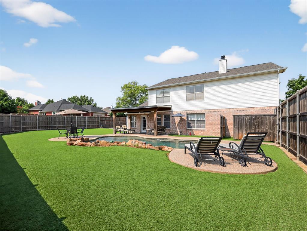 2052 Diamond Ridge Drive Carrollton, TX 75010 - Photo 16 of 40 a view of a house with backyard sitting area and furniture