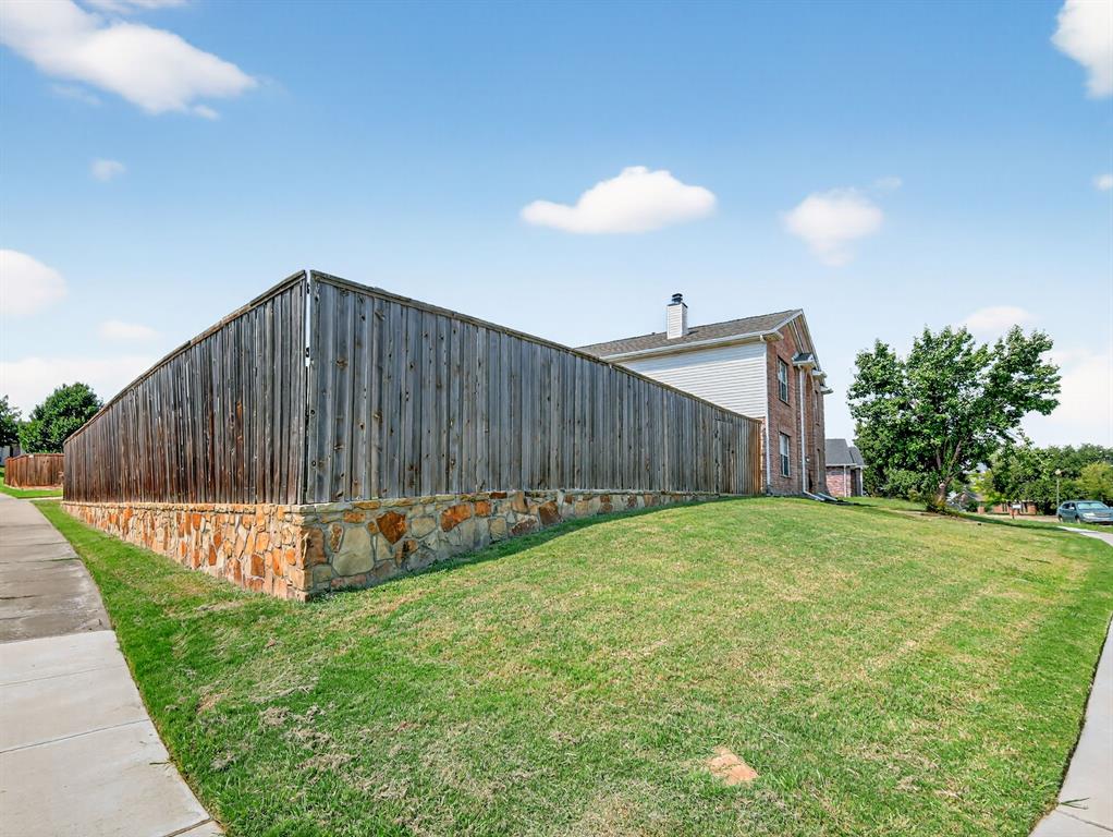 2052 Diamond Ridge Drive Carrollton, TX 75010 - Photo 17 of 40 a view of a backyard with a garden and entertaining space