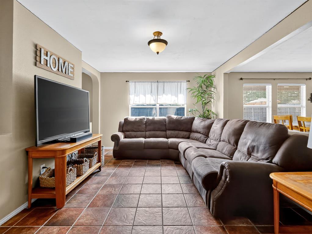 2052 Diamond Ridge Drive Carrollton, TX 75010 - Photo 25 of 40 a living room with furniture and a flat screen tv