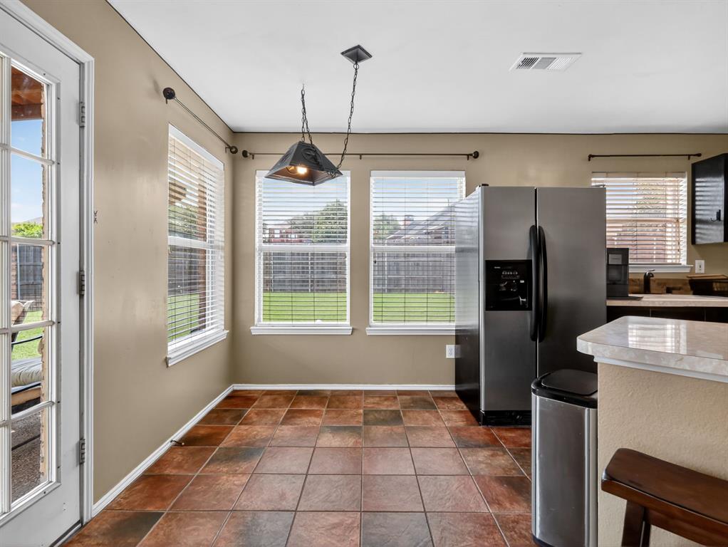 2052 Diamond Ridge Drive Carrollton, TX 75010 - Photo 32 of 40 a kitchen with a refrigerator a sink and dishwasher